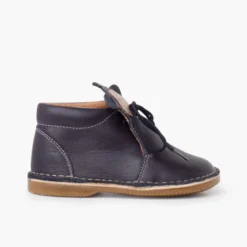 Botita piel cordones cara monito
